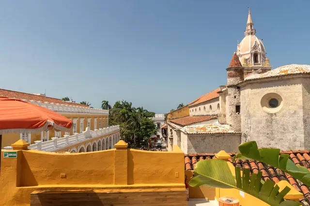 Casa Carolina rooftop with umbrellas and the Cathedral dome beyond