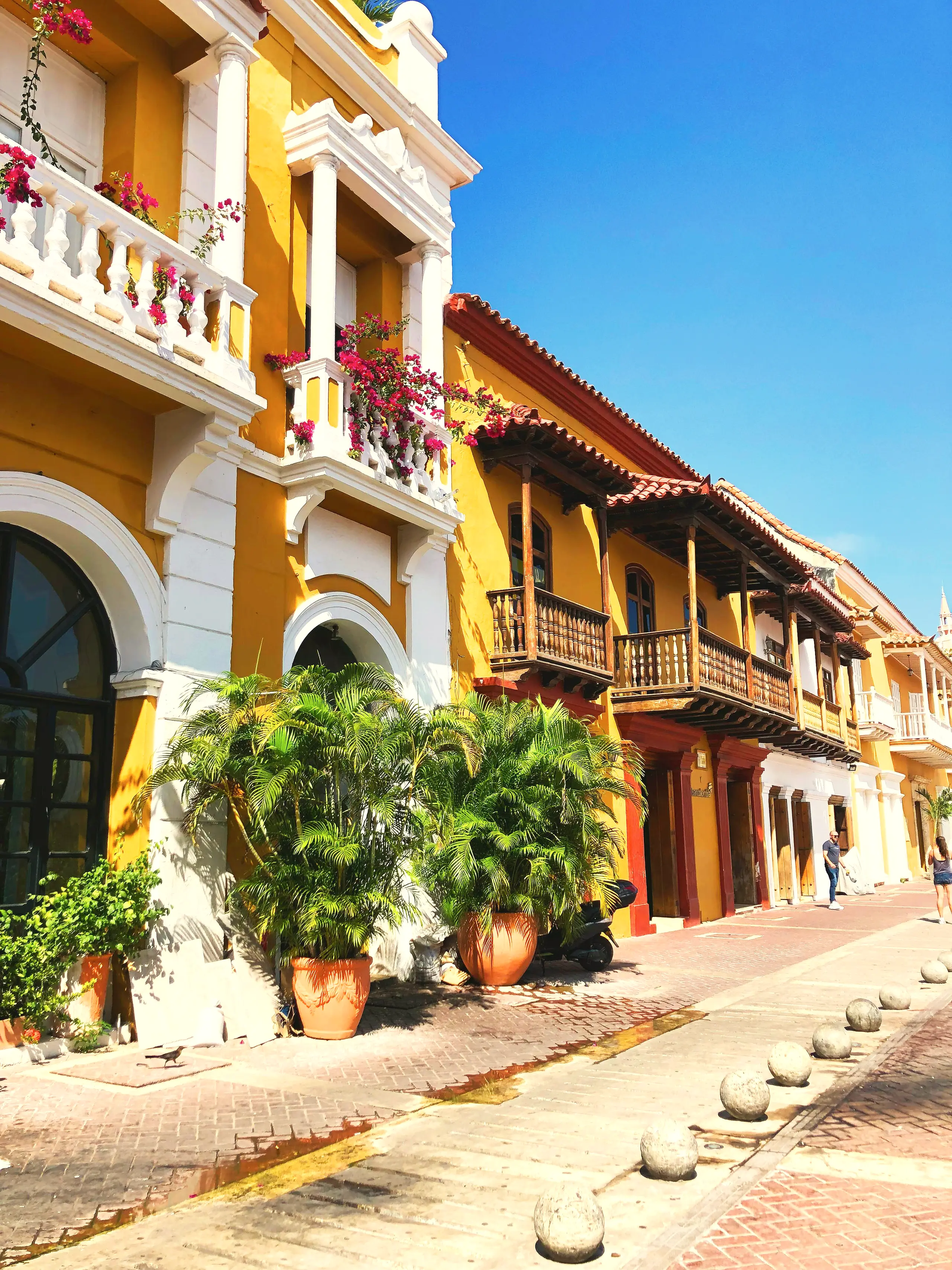 Plaza corner with yellow facades and wooden balconies