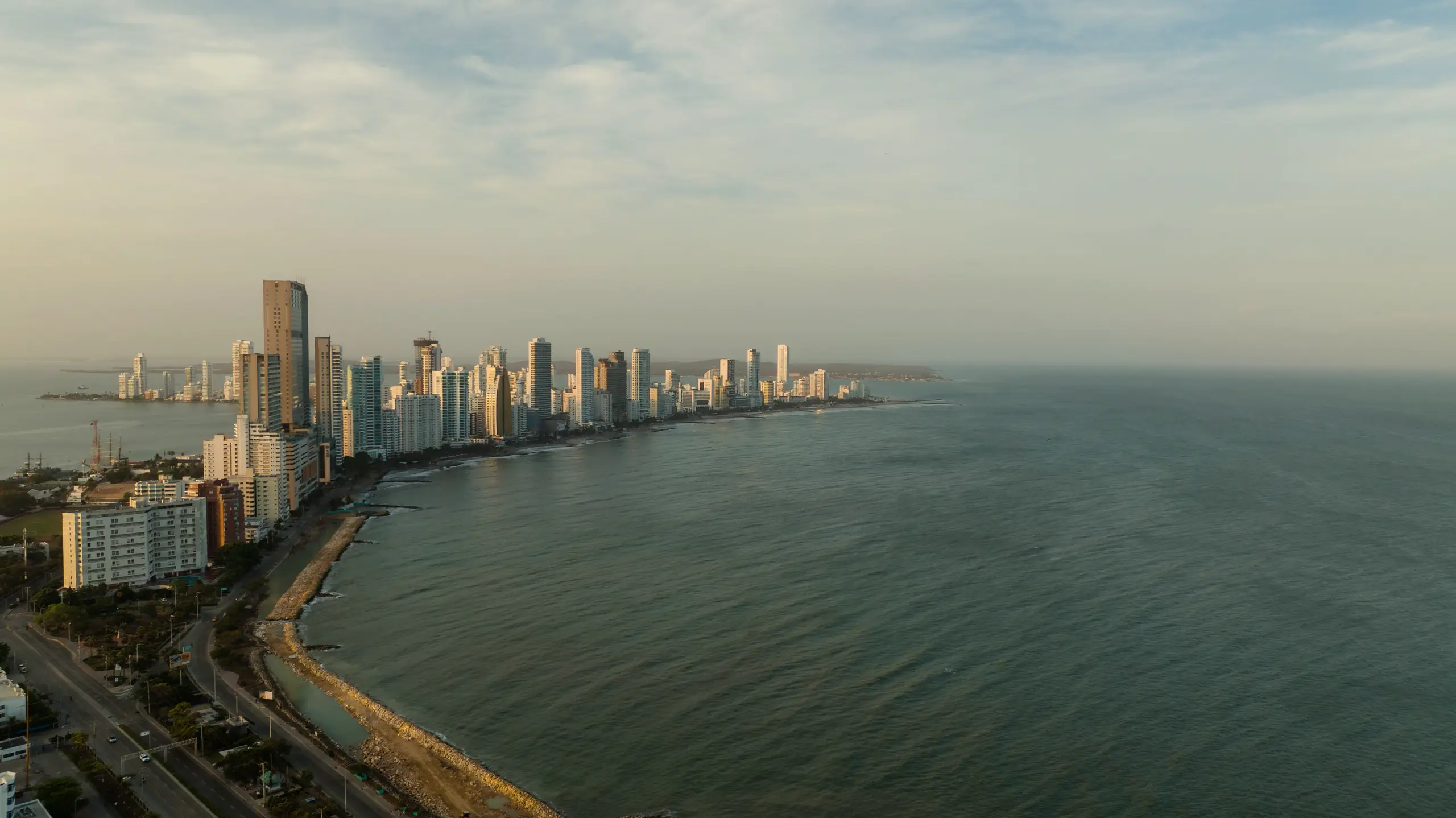 Aerial view of the coast with high-rise buildings and calm sea