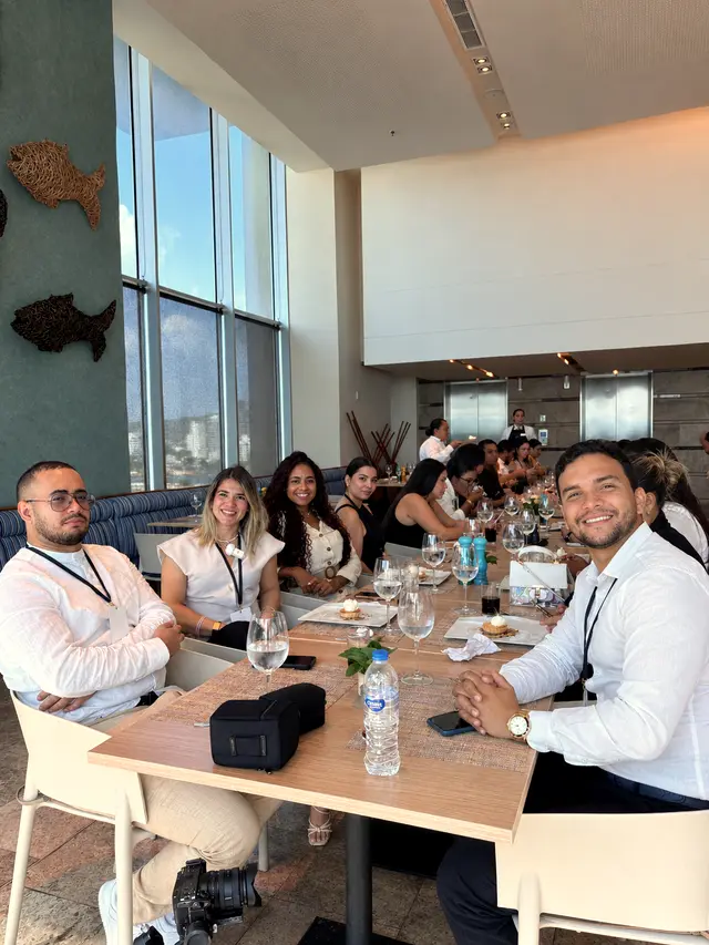 Corporate lunch table with attendees seated by a large window