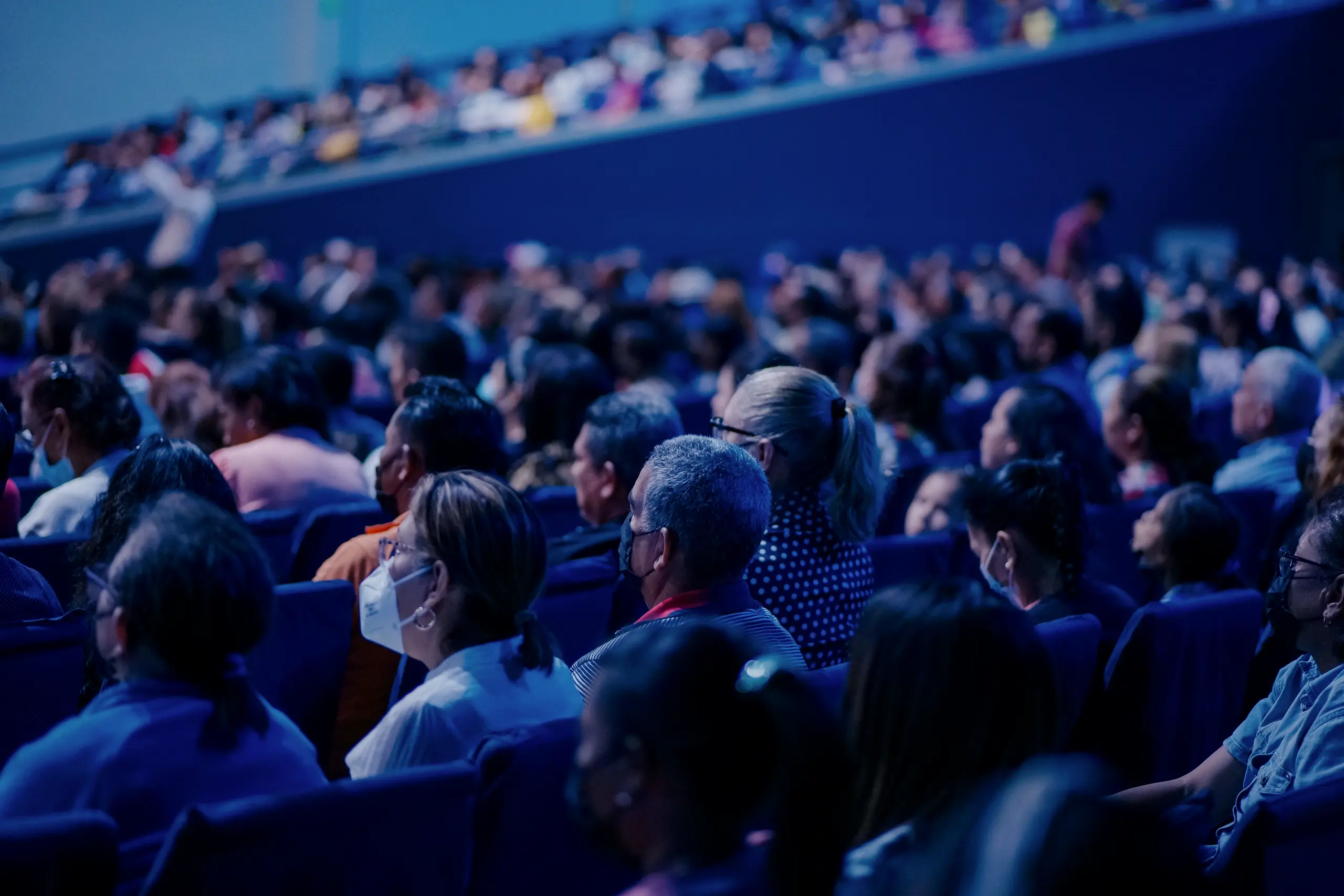 Auditorium full of attendees during a congress, in blue light