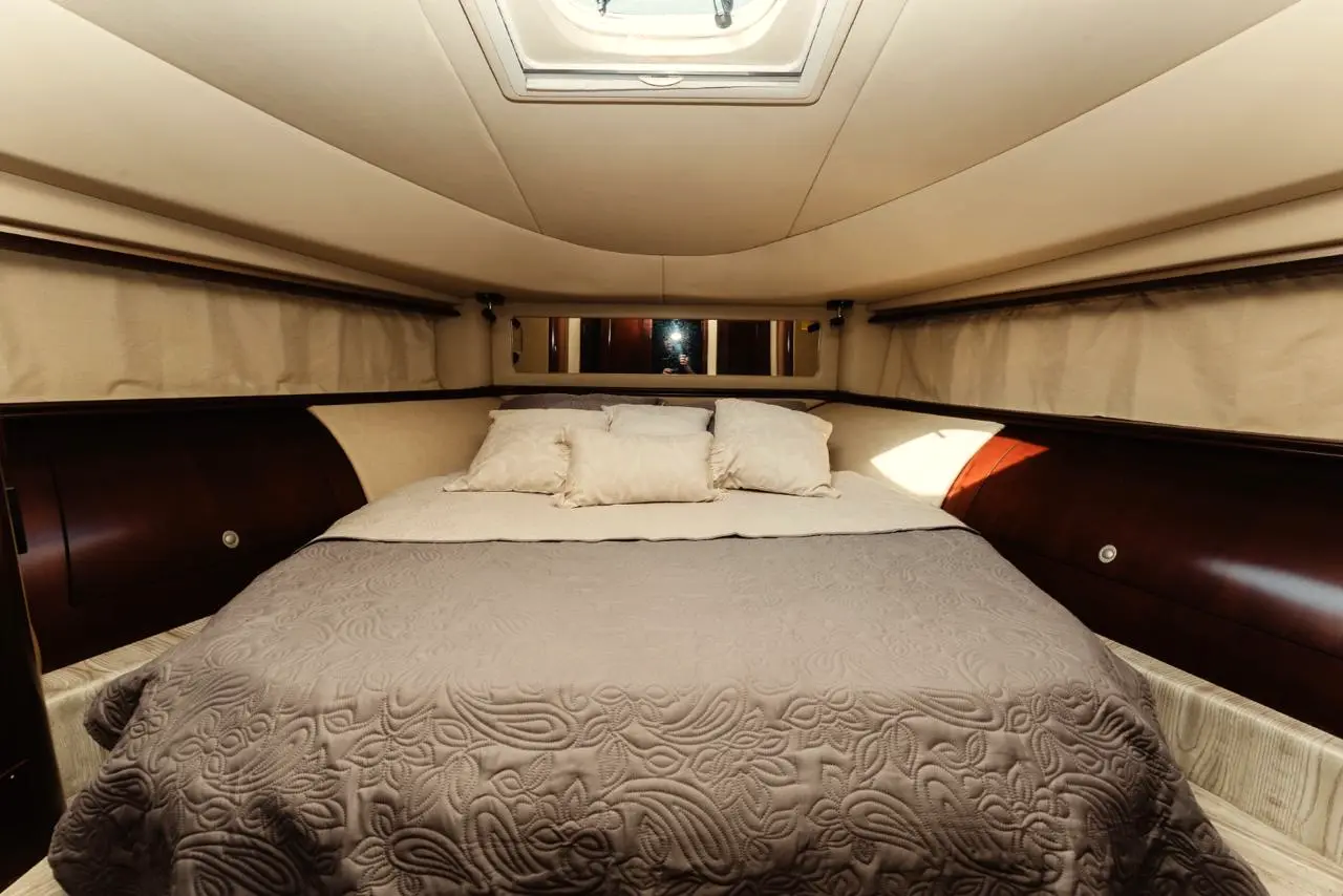 Yacht master cabin with a double bed and dark wood