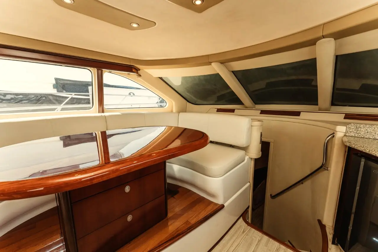 Yacht dining area and galley with dark wood and panoramic windows