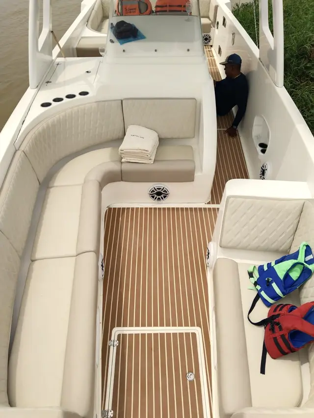 Deck with an L-shaped sofa and teak flooring seen from above