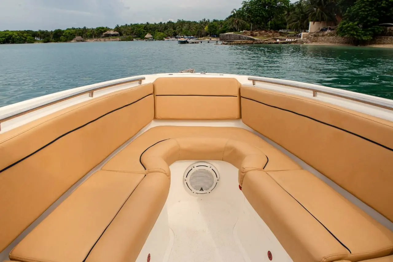 Bow with a honey-colored U-shaped leather sofa and a view of an island