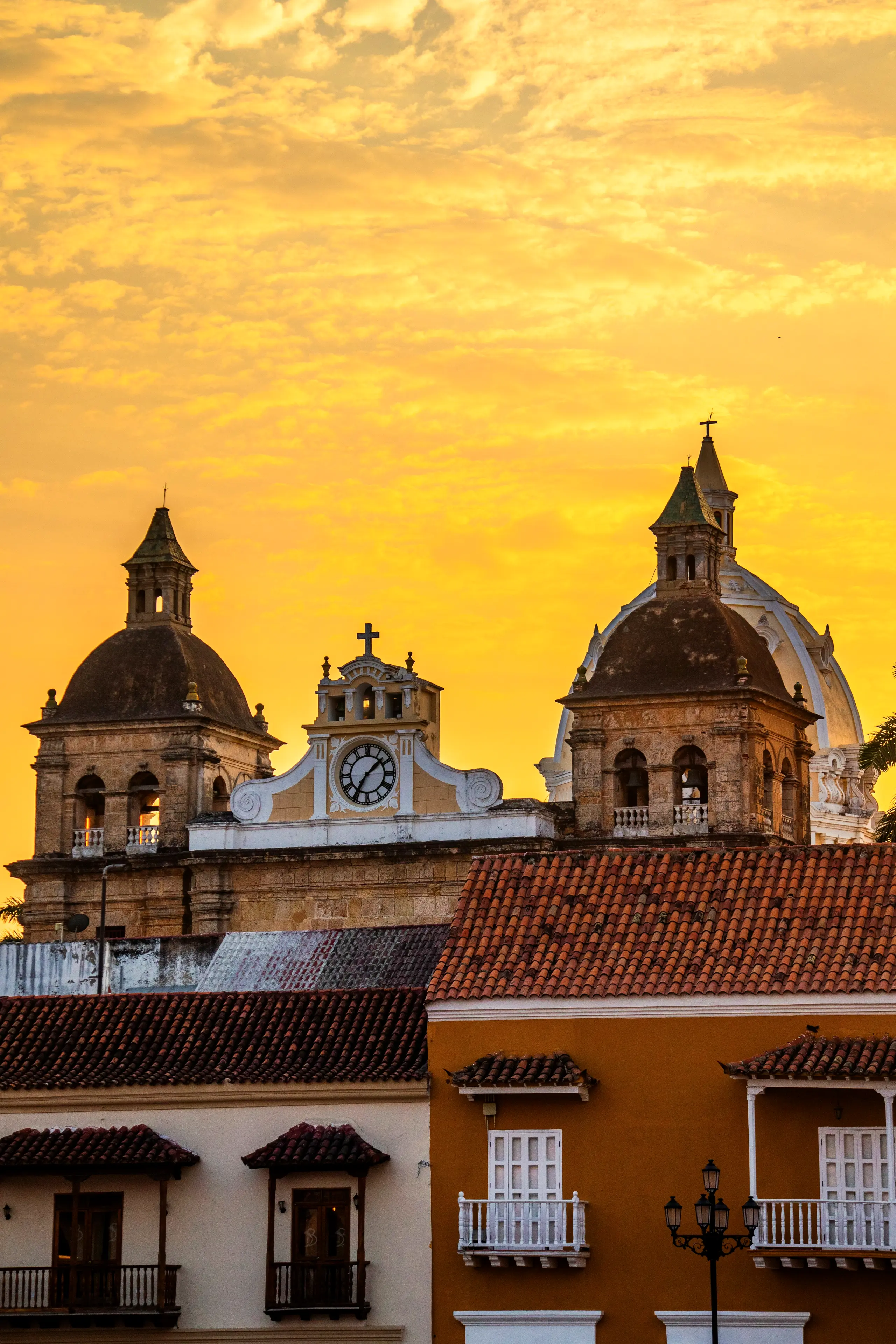 Domes and towers of the walled city's churches against a golden sky